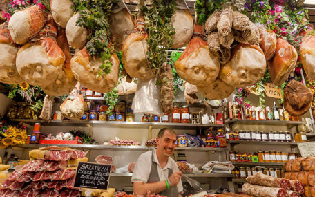 typical Italian shopkeeper with prosciutto